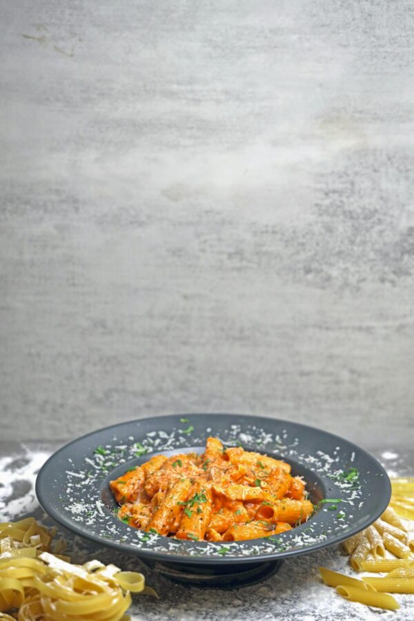 A plate of pasta with sauce and cheese